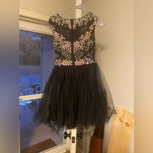 Black with beautiful large beading. Size 4 party dance dress.